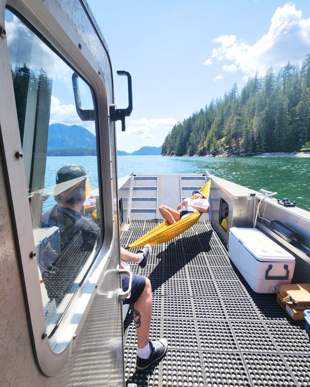 Couple relaxing on a boat during a beautiful day of fishing on the lake. They love Island Life Expeditions' fishing charters.